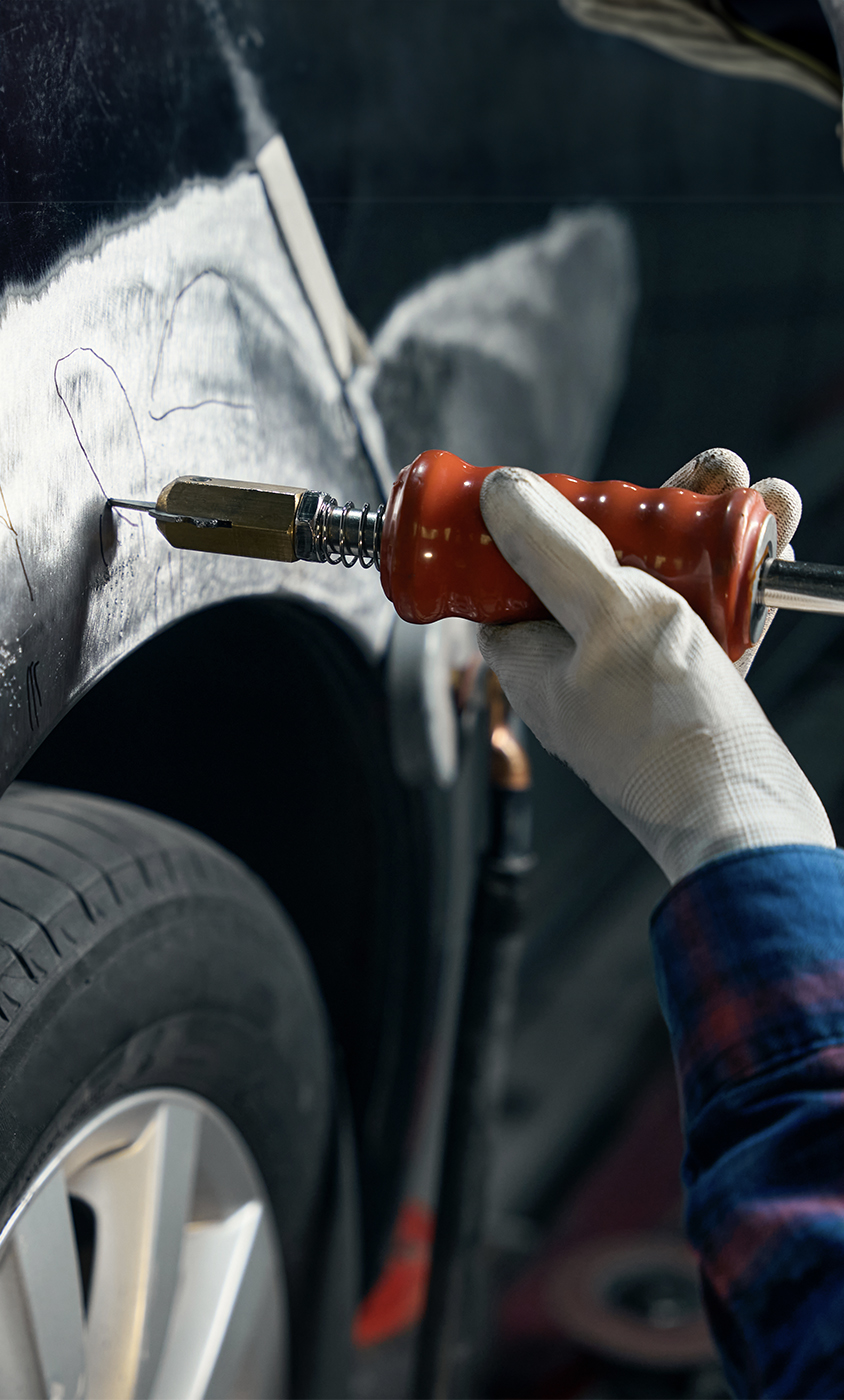 Certified technicians performing dent removal at DNA Collision Center in Houston